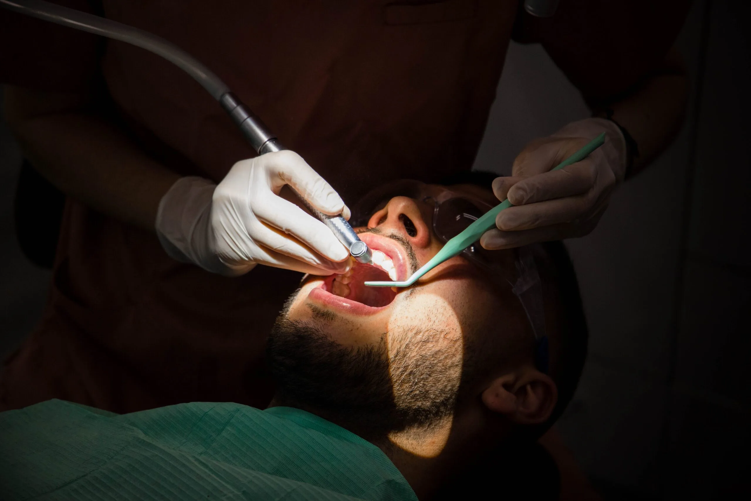 pacient in timpul unei sedinte de detartraj / igienizare dentare complete cu airflow la SDS, dentist Bucuresti